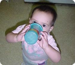 ребенок пьет из чашки